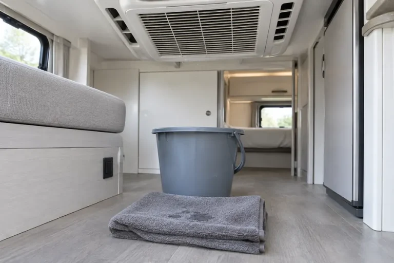 Bucket and towel under an RV AC to catch melting ice